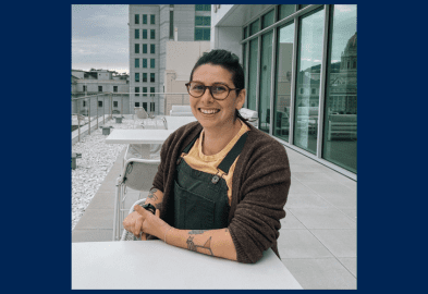 A portrait Yasmin Thompson with the San Francisco Civic Center in the background.